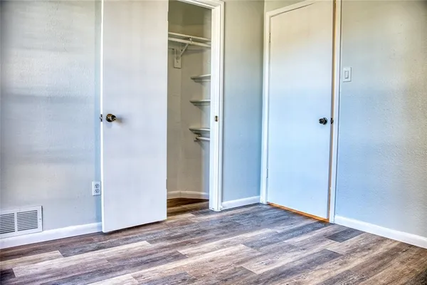 a view of a room with wooden floor