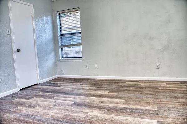 a view of a room with window and wooden floor