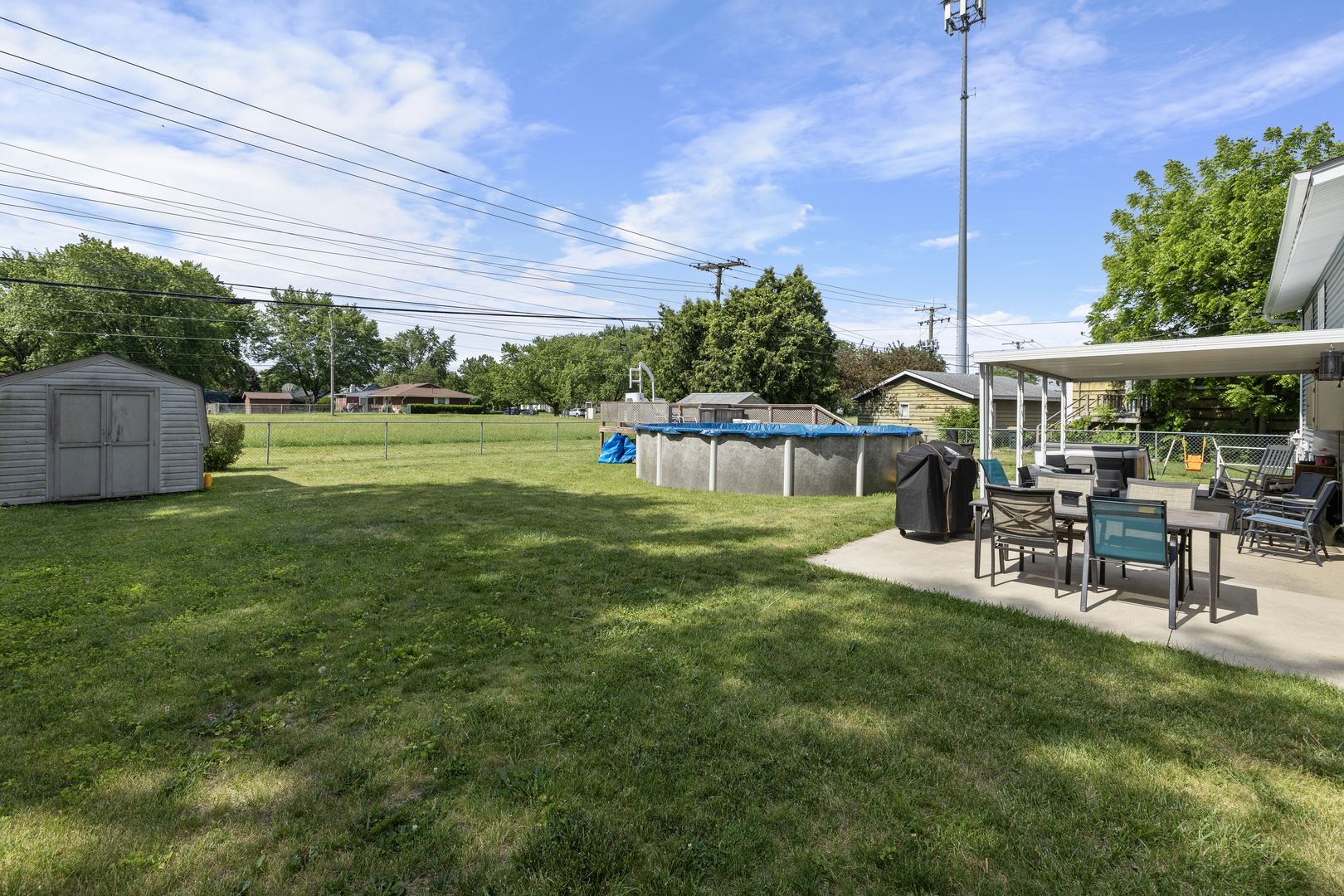 4 Saugatuck Road Montgomery, IL 60538 - Photo 3 of 24 a view of a swimming pool with lawn chairs and a large tree