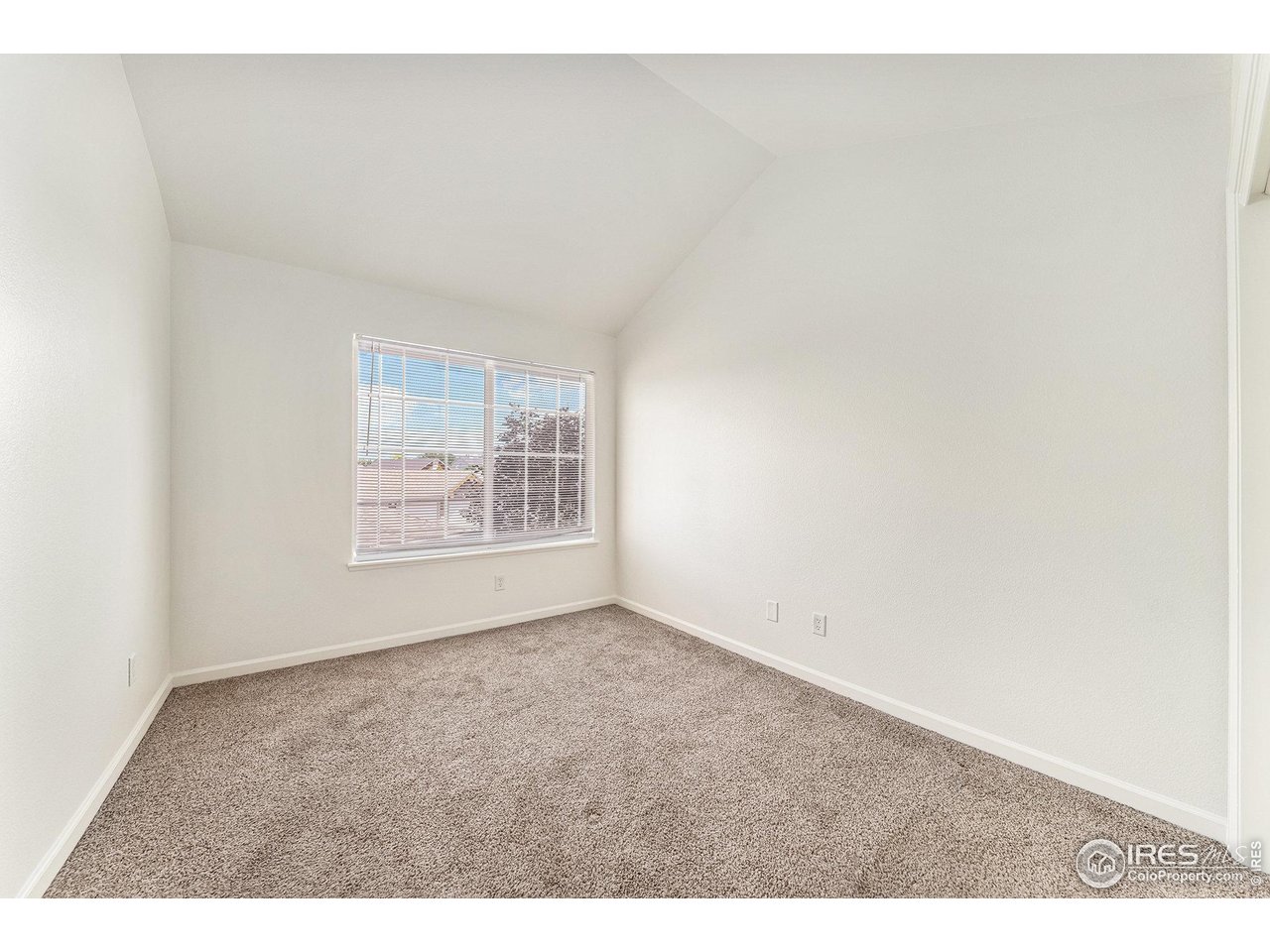 124 Beacon Way, Unit 3 Windsor, CO 80550 - Photo 13 of 22 a view of an empty room and window