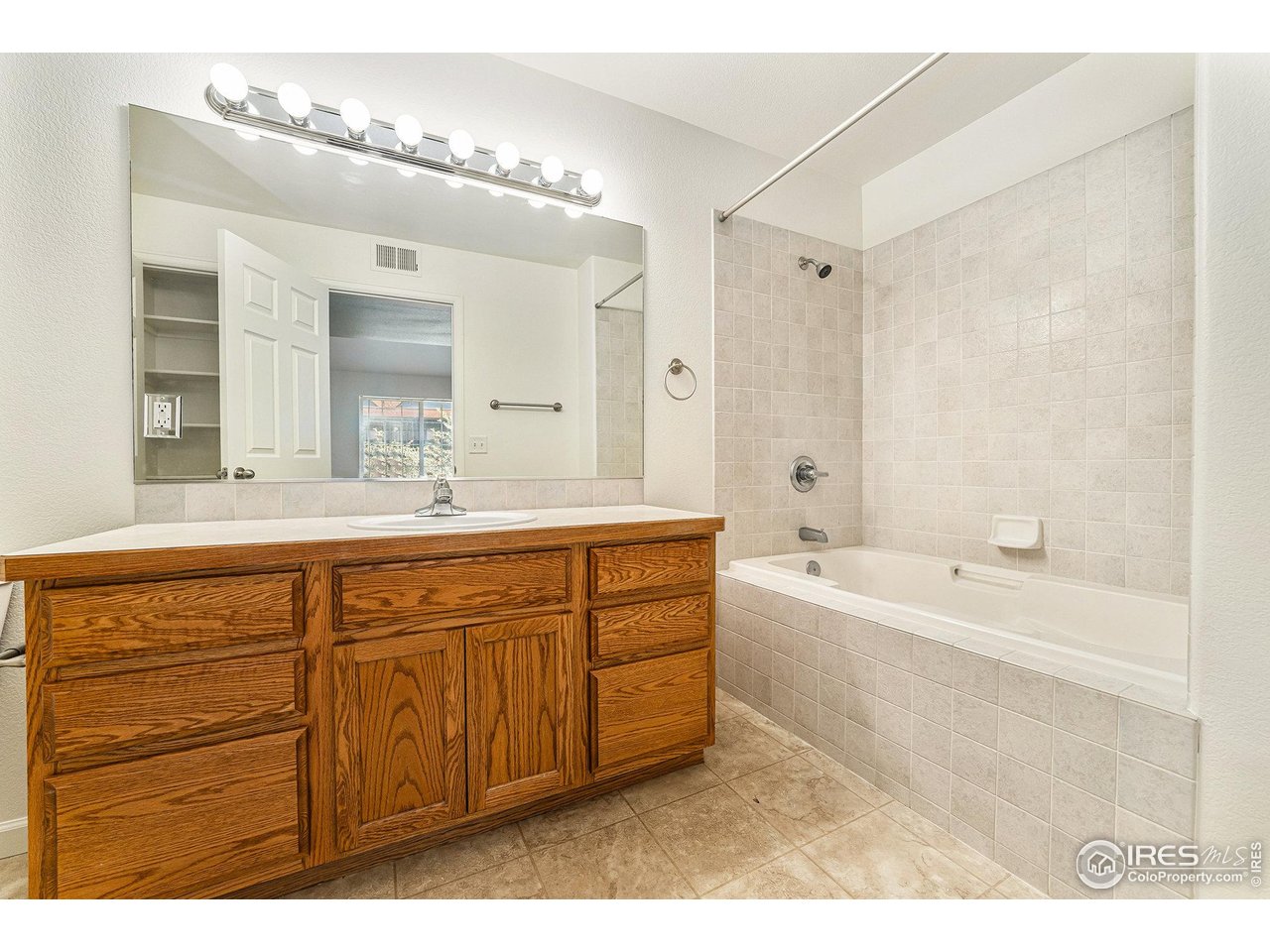 124 Beacon Way, Unit 3 Windsor, CO 80550 - Photo 18 of 22 a spacious bathroom with a tub sink and mirror
