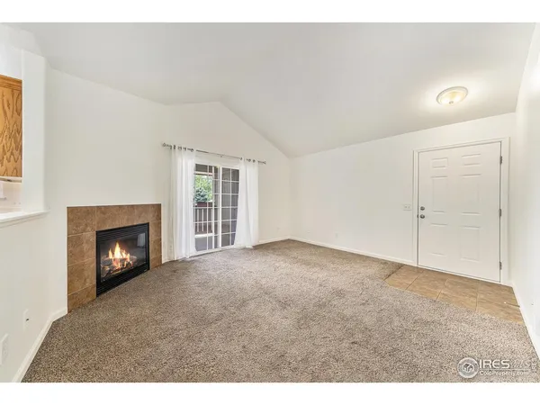 a view of empty room with a fireplace