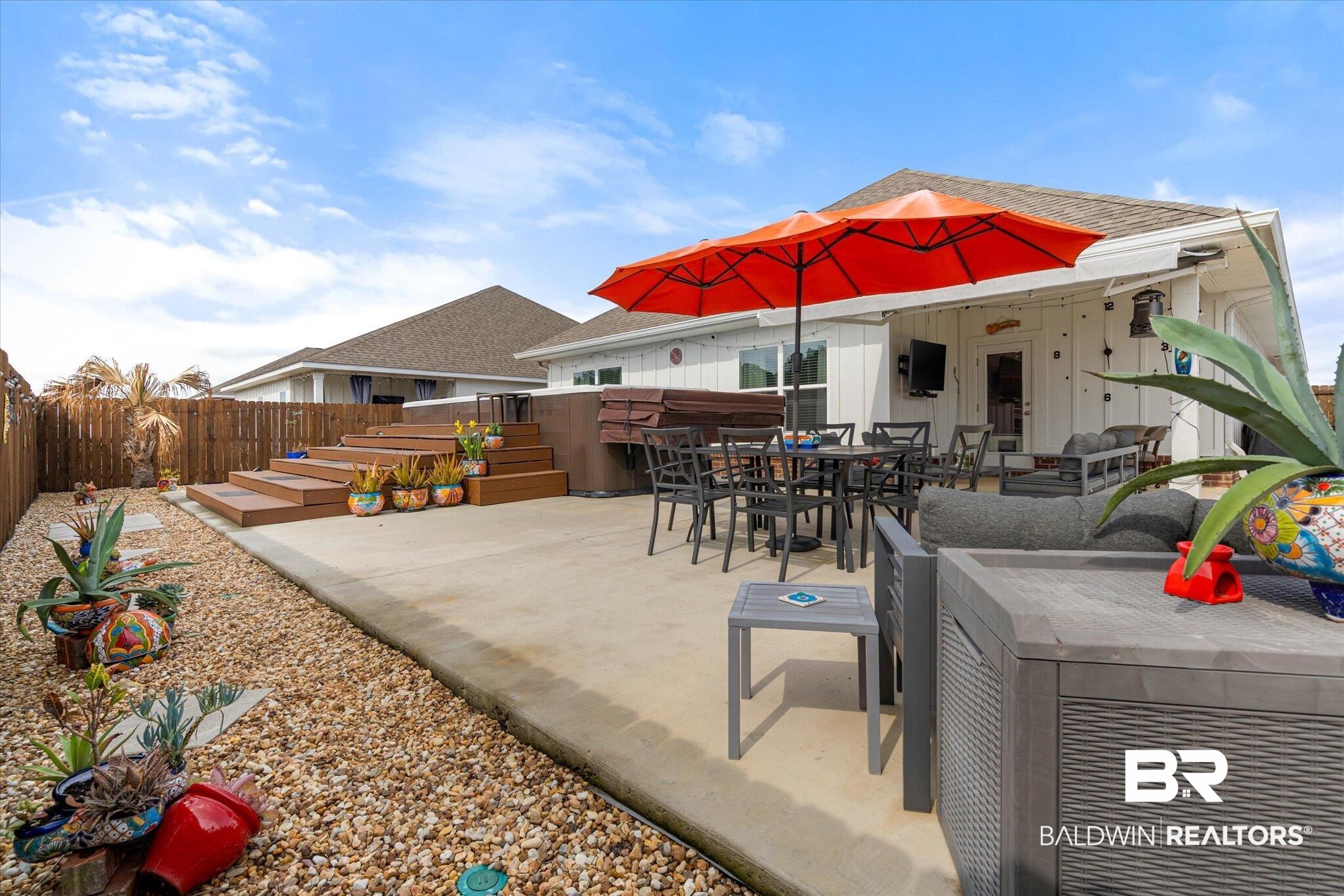 23246 Lieutenant Avenue Foley, AL 36535 - Photo 30 of 36 View of patio / terrace featuring a jacuzzi