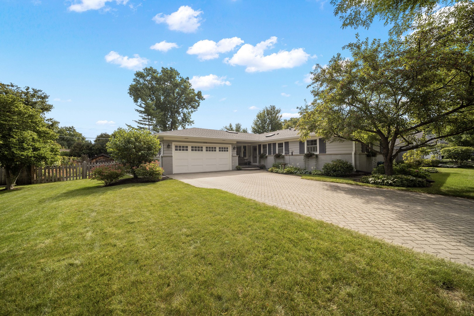 a view of house with outdoor space and tree s