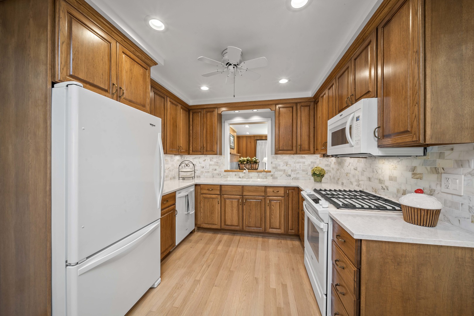 275 Ingram Street Northfield, IL 60093 - Photo 12 of 29 a kitchen with stainless steel appliances granite countertop a refrigerator a sink dishwasher a stove and white countertops with wooden floor