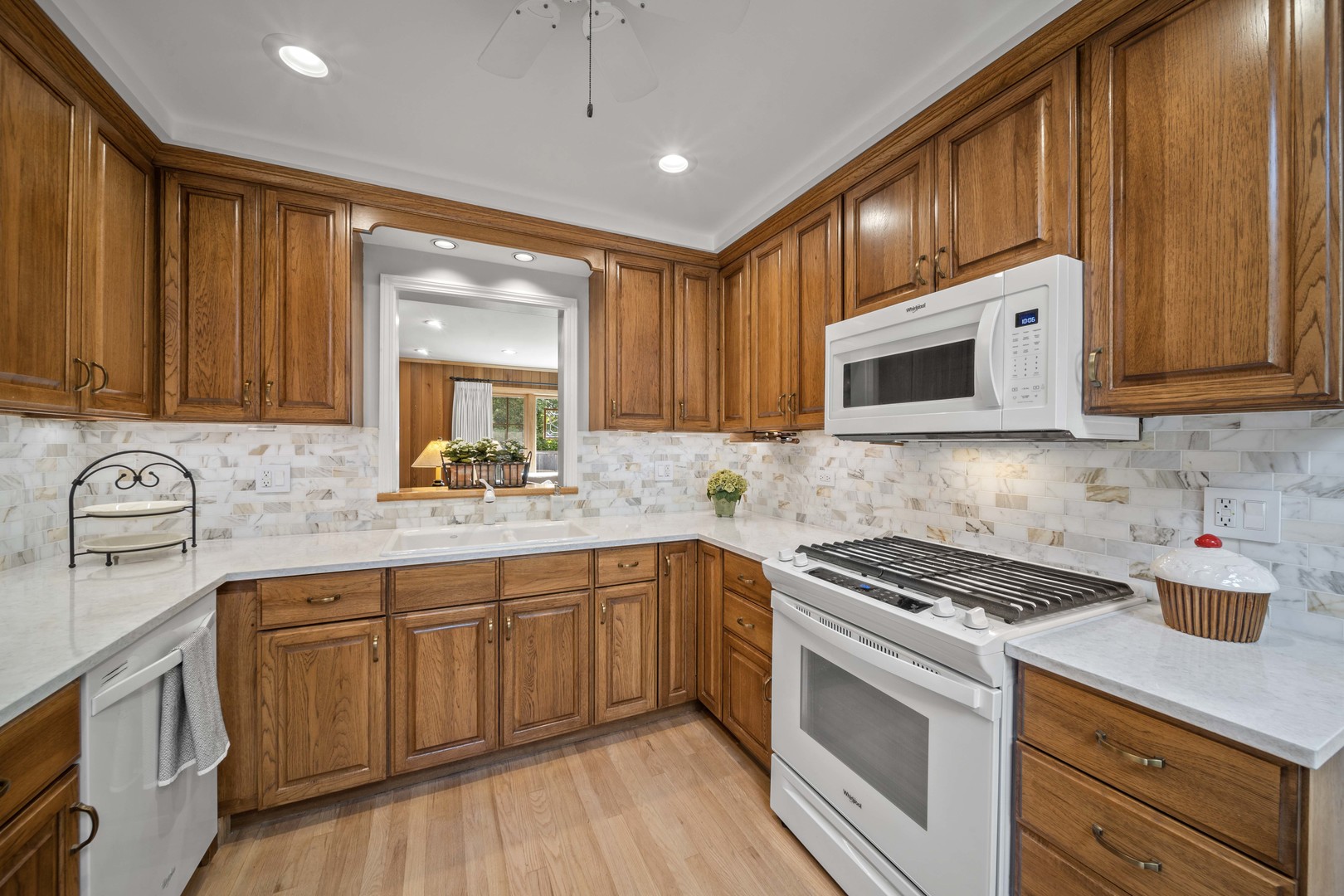 275 Ingram Street Northfield, IL 60093 - Photo 13 of 29 a kitchen with stainless steel appliances granite countertop wooden cabinets stove top oven and sink