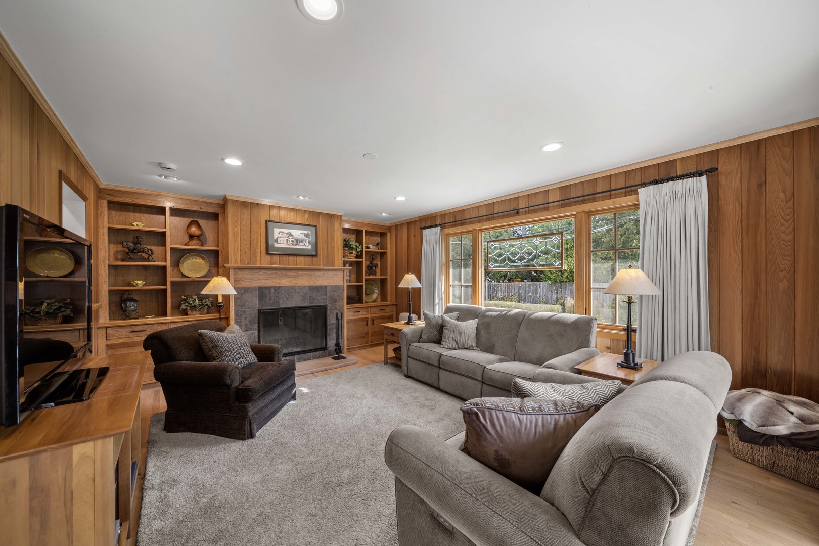 275 Ingram Street Northfield, IL 60093 - Photo 19 of 29 a living room with furniture a fireplace and a large window