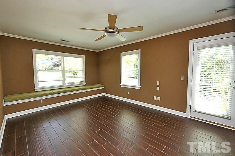 4605 Pitt Street Raleigh, NC 27609 - Photo 13 of 22 a view of an empty room with wooden floor and a window