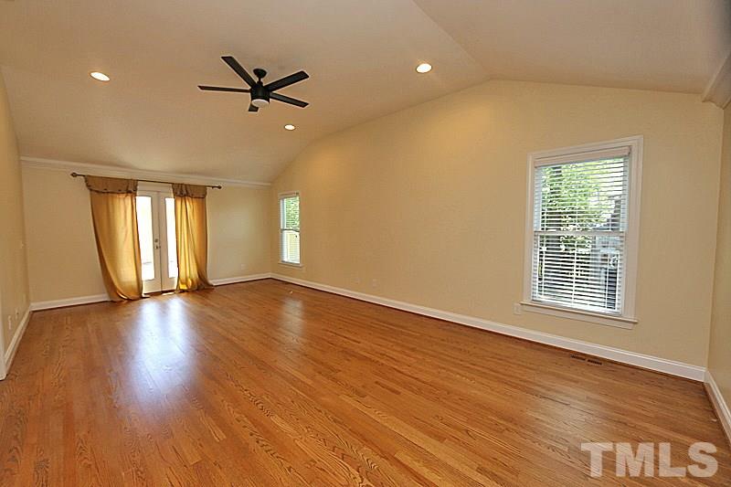 4605 Pitt Street Raleigh, NC 27609 - Photo 15 of 22 a view of an empty room with wooden floor and a window