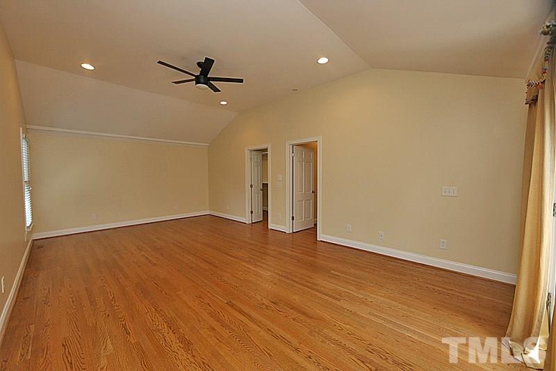 4605 Pitt Street Raleigh, NC 27609 - Photo 16 of 22 an empty room with wooden floor and windows