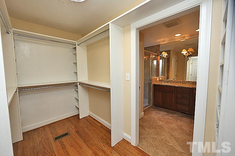 4605 Pitt Street Raleigh, NC 27609 - Photo 18 of 22 a view of walk in closet with wooden floor and a window