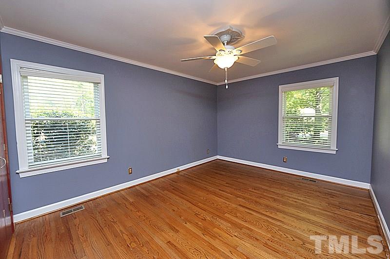 4605 Pitt Street Raleigh, NC 27609 - Photo 19 of 22 a view of an empty room with a window and wooden floor