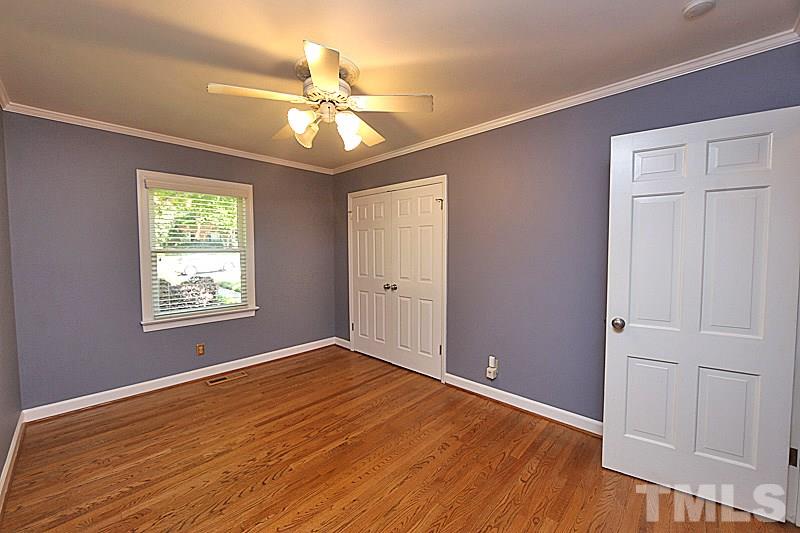 4605 Pitt Street Raleigh, NC 27609 - Photo 20 of 22 a view of an empty room with wooden floor and a window