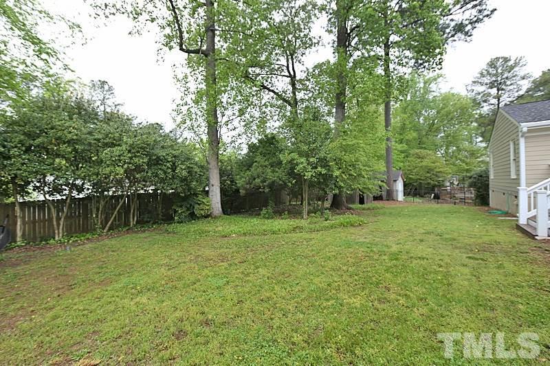 4605 Pitt Street Raleigh, NC 27609 - Photo 3 of 22 a backyard of a house with lots of green space and fountain