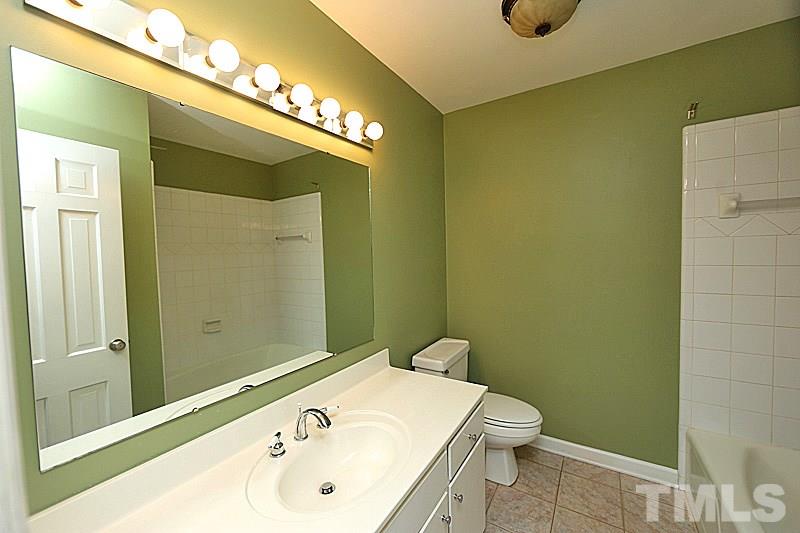 4605 Pitt Street Raleigh, NC 27609 - Photo 21 of 22 a bathroom with a sink and a mirror