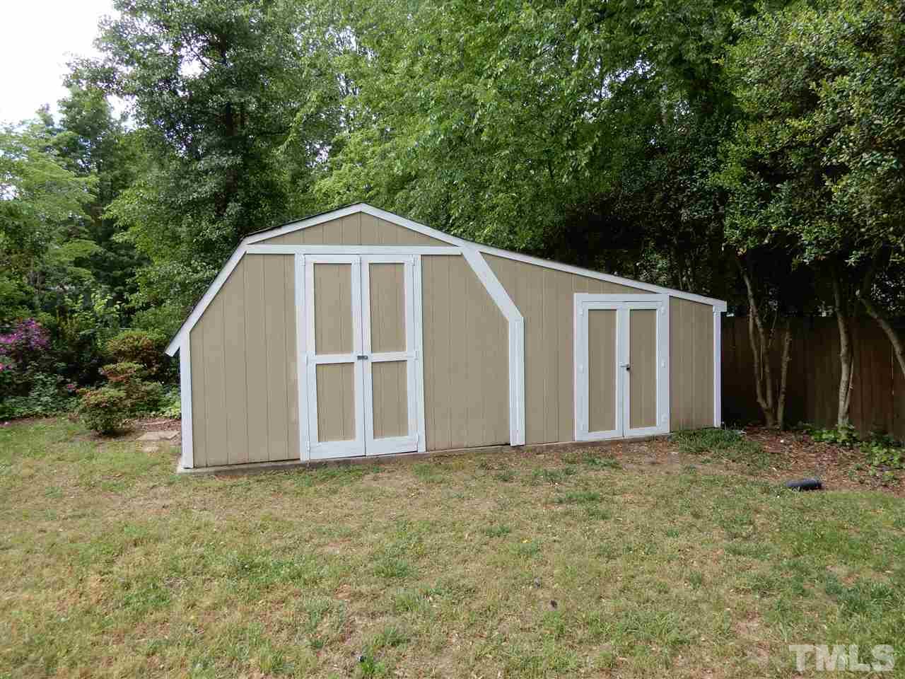 4605 Pitt Street Raleigh, NC 27609 - Photo 22 of 22 a white house with a large trees and yard