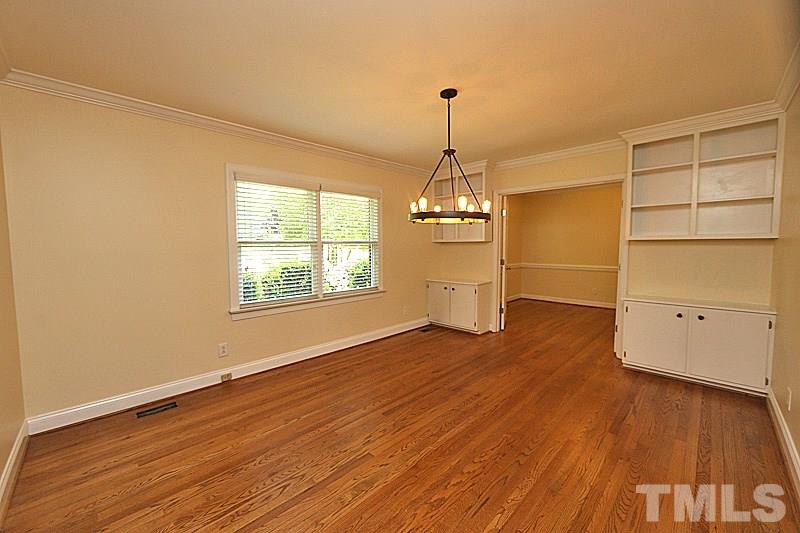 4605 Pitt Street Raleigh, NC 27609 - Photo 4 of 22 a view of empty room with wooden floor and window