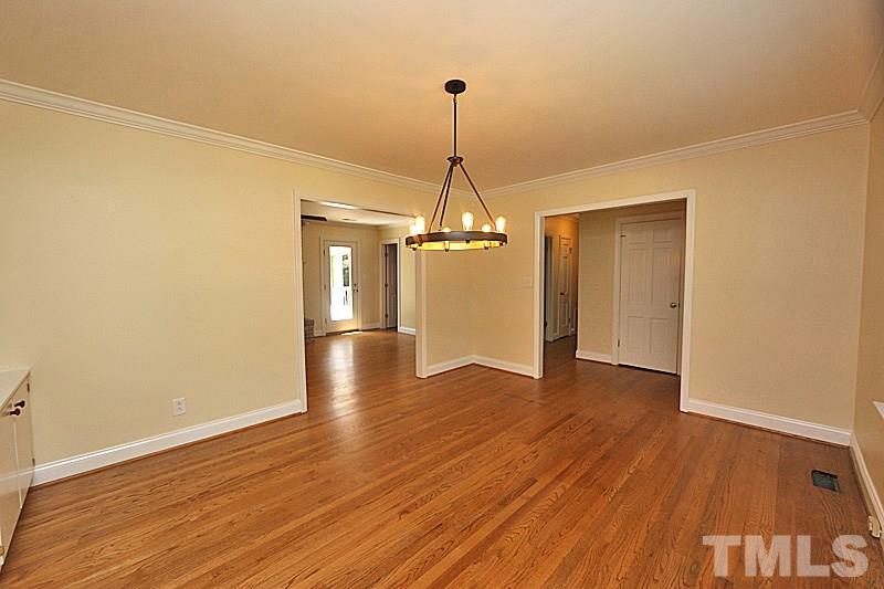 4605 Pitt Street Raleigh, NC 27609 - Photo 5 of 22 a view of a room with wooden floor air conditioner and windows