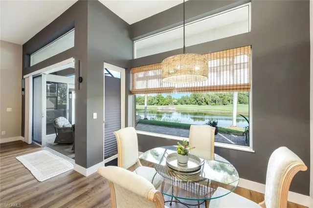 a view of a dining room with furniture wooden floor and a chandelier