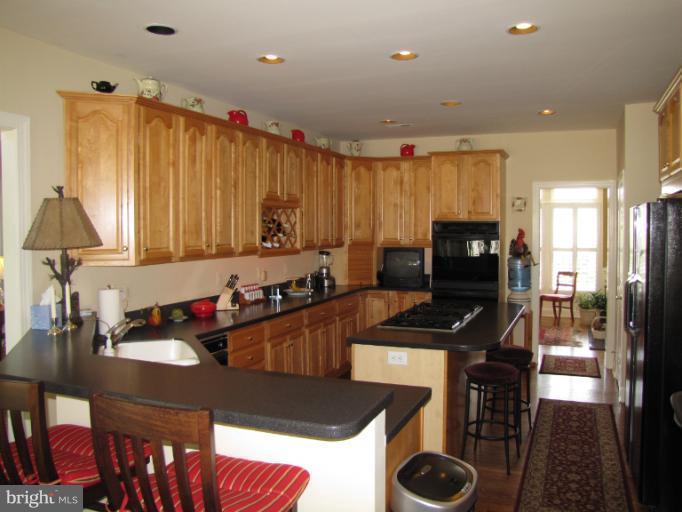 2208 Link Road Silver Spring, MD 20905 - Photo 23 of 30 a kitchen with a dining table cabinets and appliances
