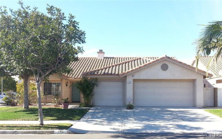 749 Raft Lane Oxnard, CA 93035 - Photo 1 of 14 a front view of a house with a yard and garage