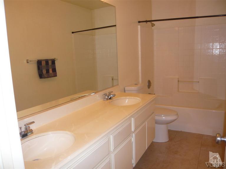 749 Raft Lane Oxnard, CA 93035 - Photo 5 of 14 a bathroom with a granite countertop sink a toilet and shower