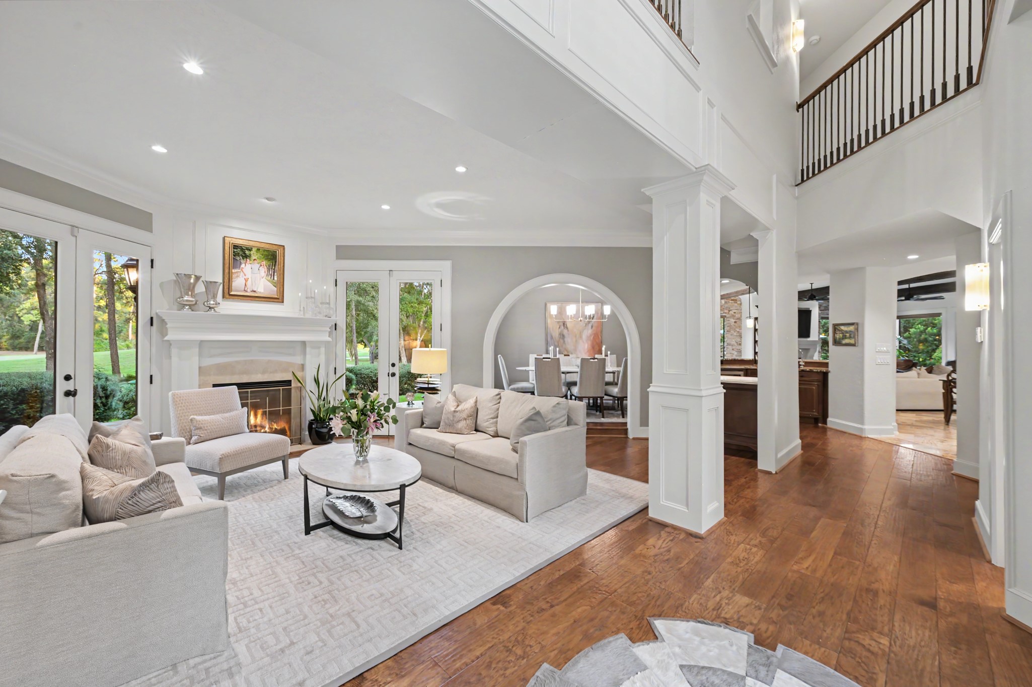 22 Watertree Court Spring, TX 77380 - Photo 5 of 45 Elegant formal living room highlighted by soaring ceilings and an open flow into the formal dining area.