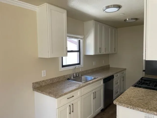 a kitchen with a sink and cabinets