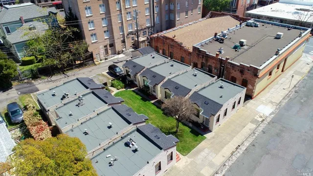 an aerial view of a house with a yard