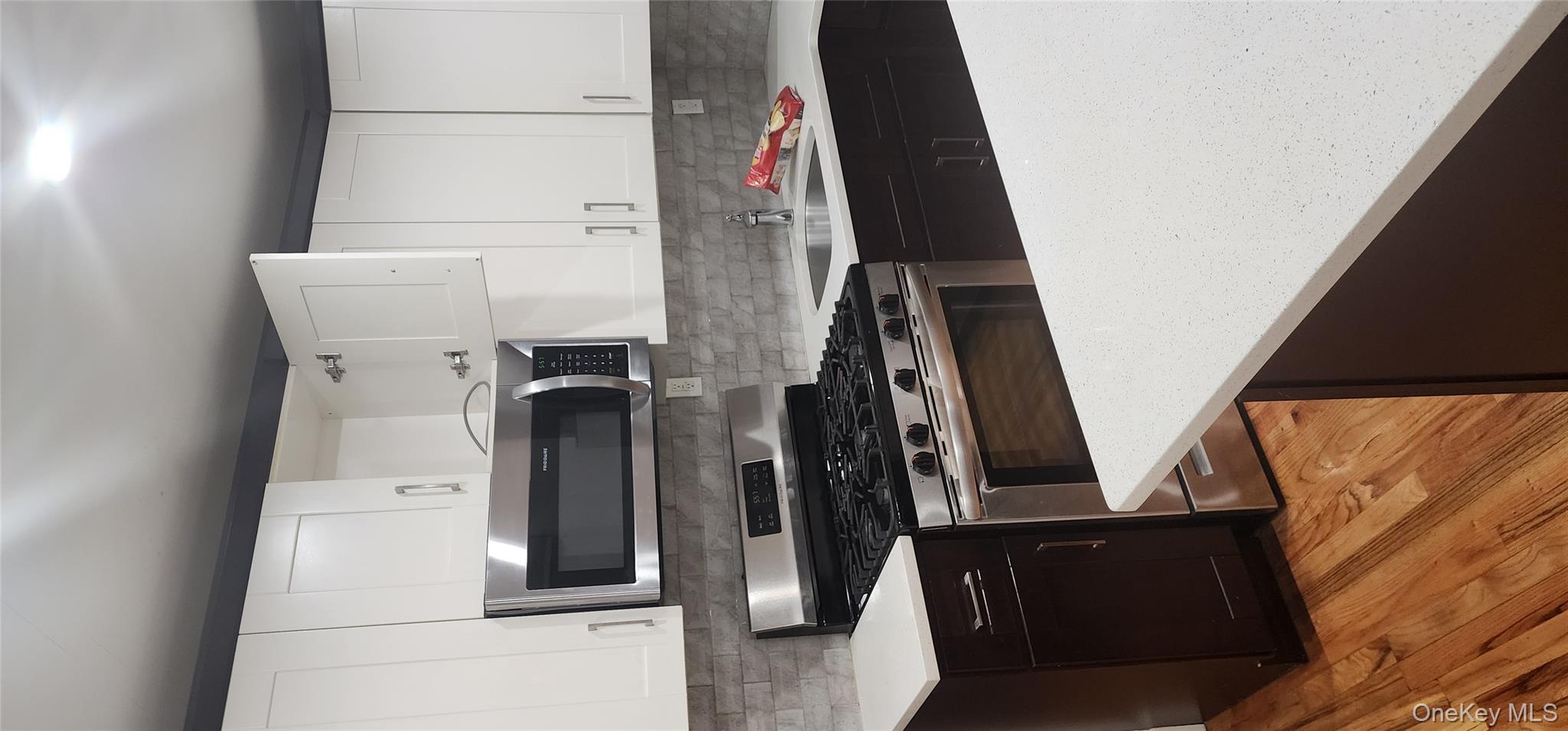 a kitchen with stainless steel appliances a stove a sink and a microwave