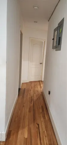 a view of hallway with wooden floor