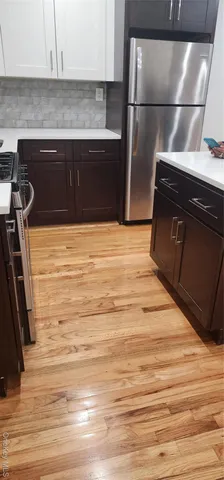 a kitchen with a refrigerator and a stove