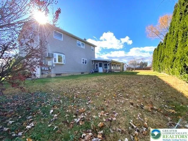 a view of a yard with a house in the background