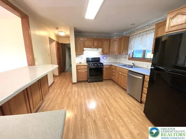 a kitchen with a sink appliances and cabinets