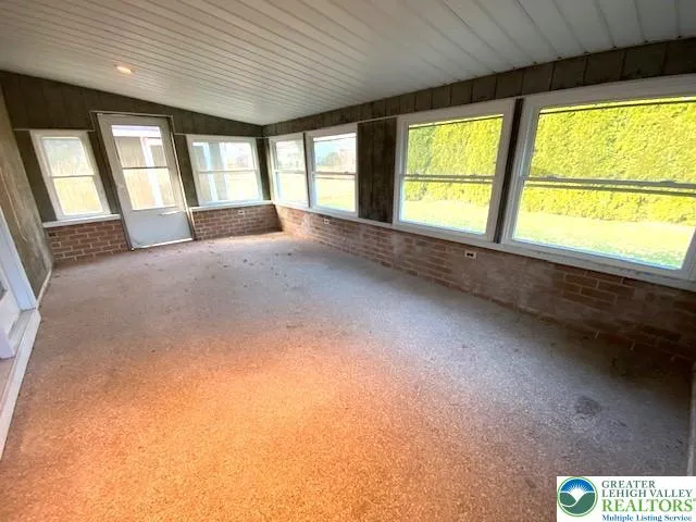 a large room with a large window and front door