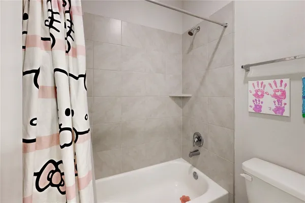 a bathroom with a shower and a toilet
