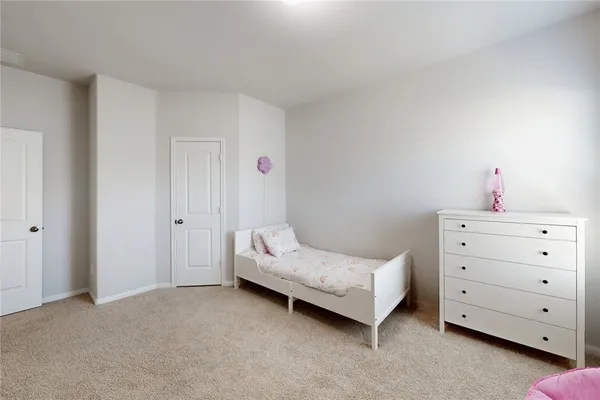 a bedroom with a bed and cabinets