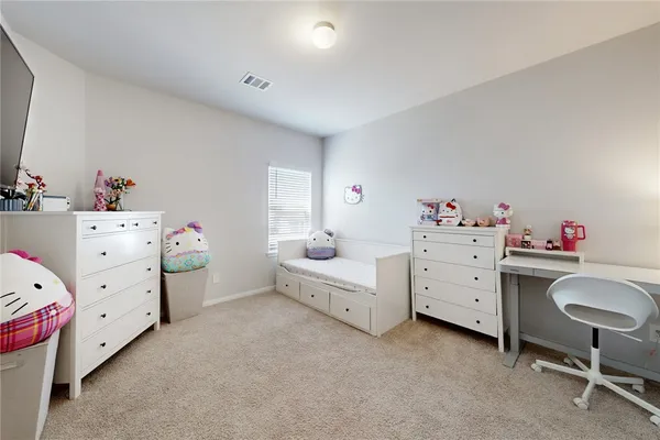 a room with a baby bed baby desk and a baby crib