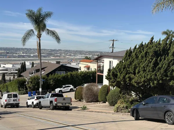 a view of a cars park in front of a building