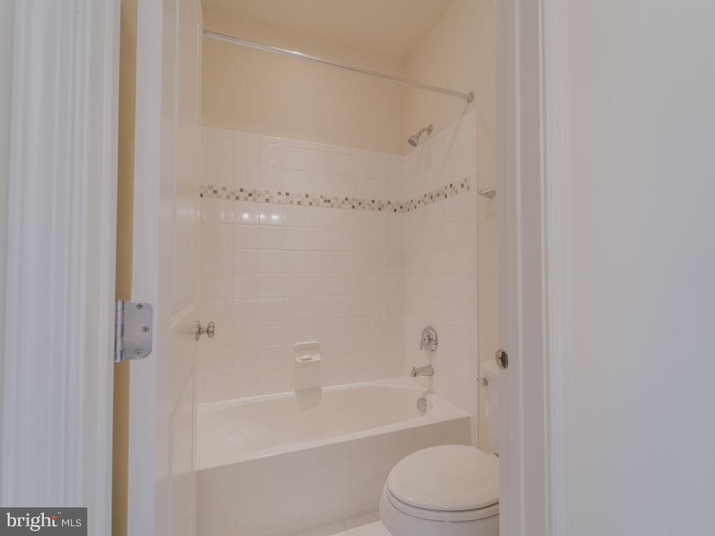 22595 Windsor Locks Square Ashburn, VA 20148 - Photo 49 of 56 a bathroom with a toilet and a bathtub