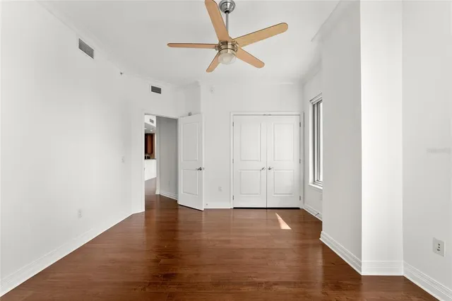 a view of an empty room with wooden floor