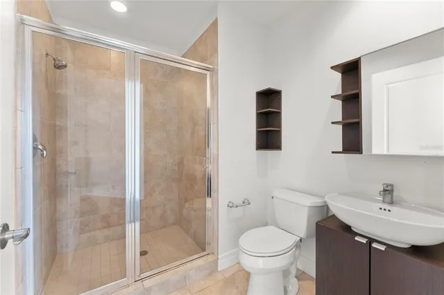 a bathroom with a sink toilet and shower