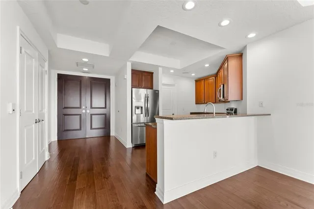 a view of kitchen with refrigerator microwave and wooden floor