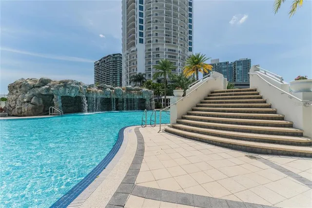 a view of a house with swimming pool and sitting area