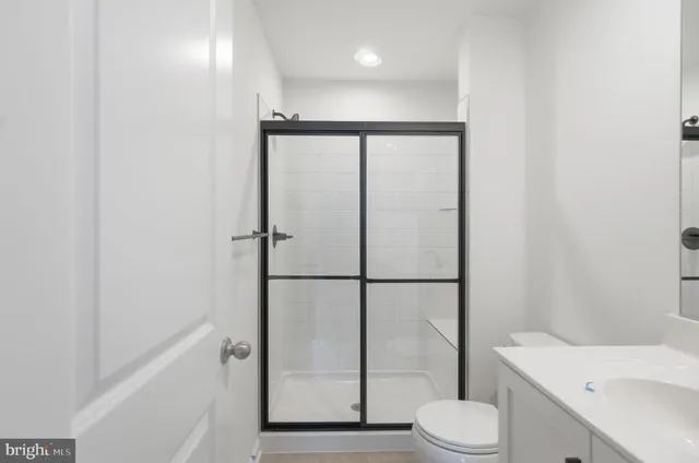 a bathroom with a toilet a sink and a shower