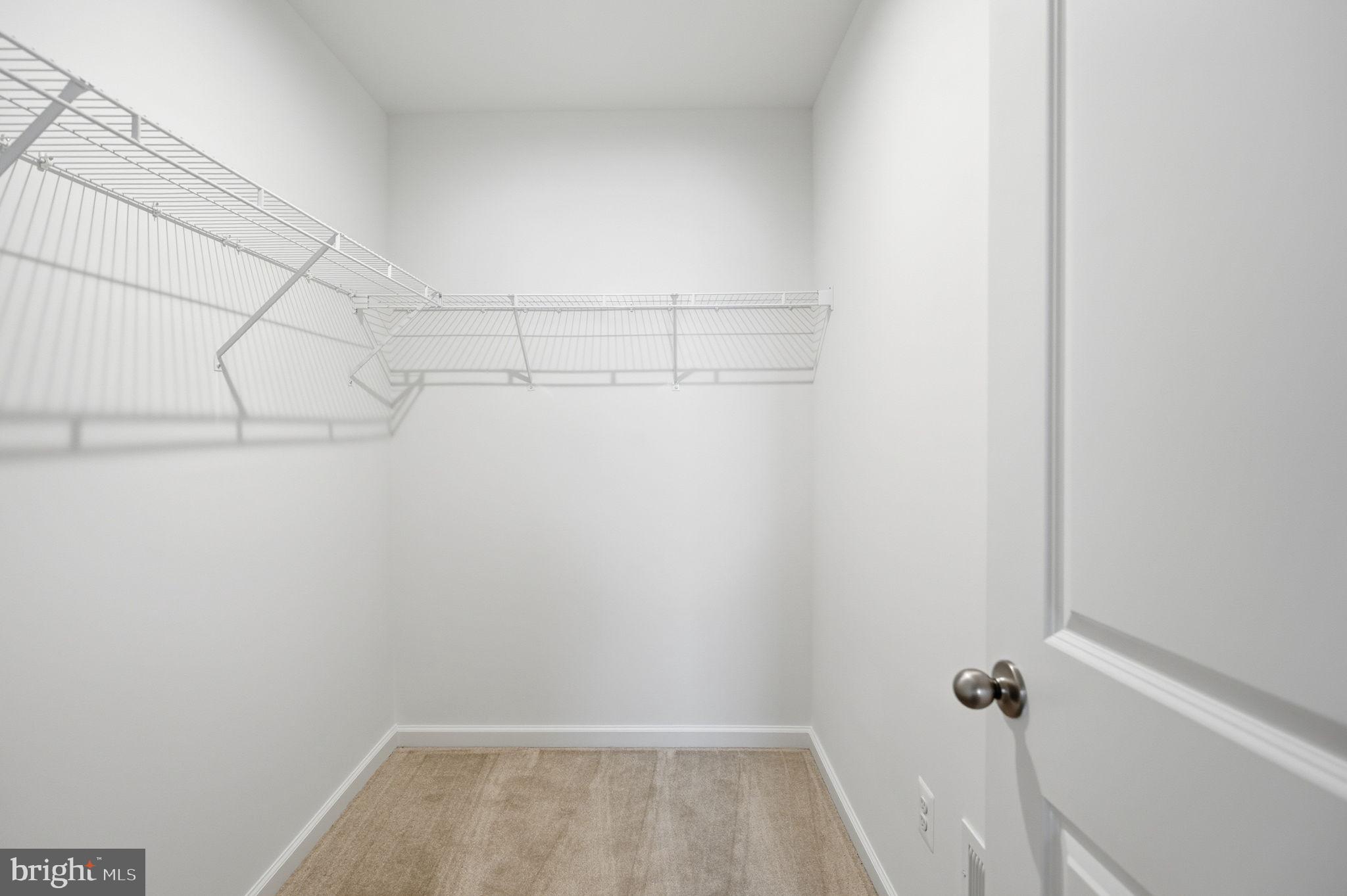 Tbb Tbb Outrigger Road, Unit WEXFORD Inwood, WV 25428 - Photo 13 of 34 a view of a room with racks on the wall