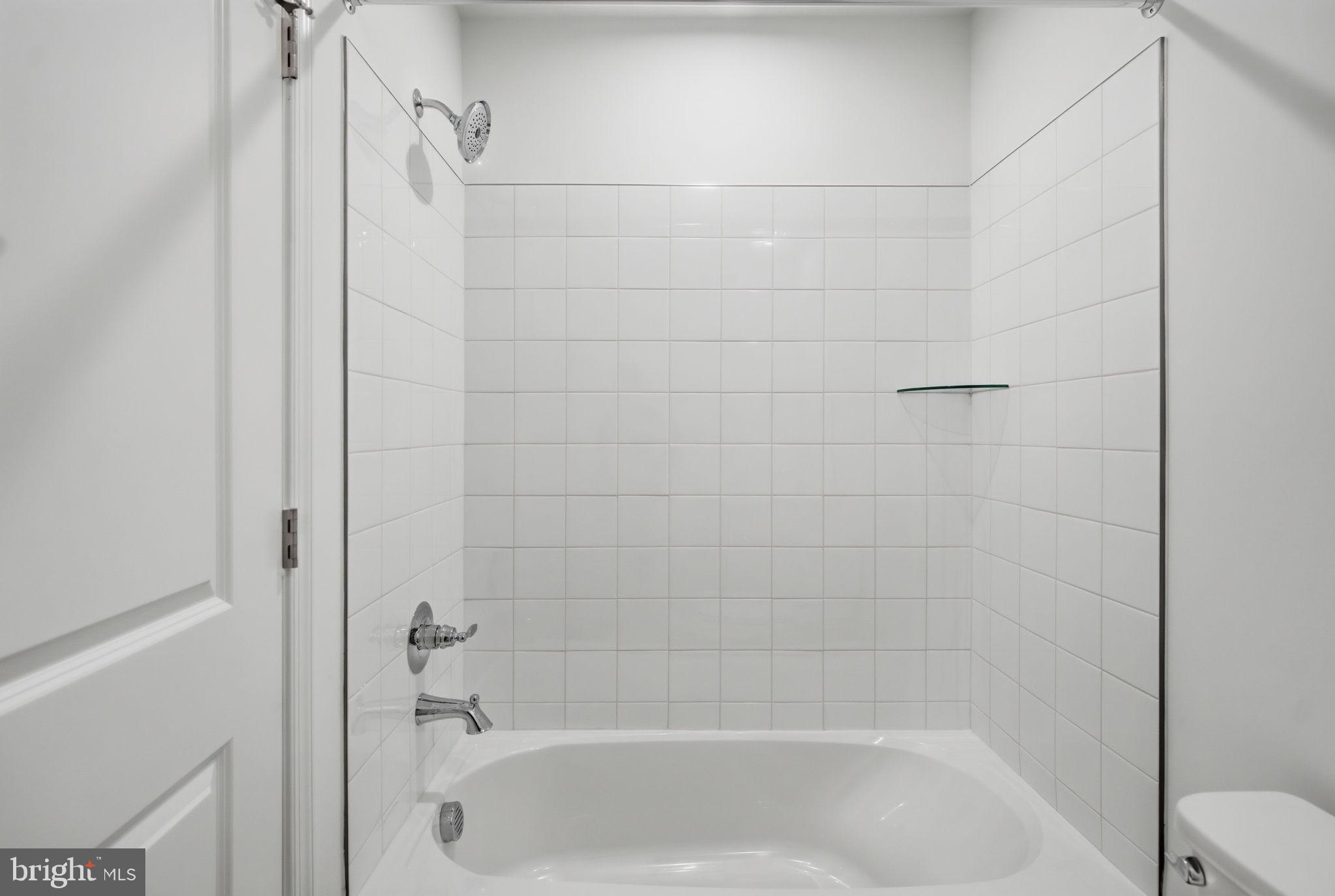 Tbb Tbb Outrigger Road, Unit WEXFORD Inwood, WV 25428 - Photo 15 of 34 a close up of a bathtub in a bathroom