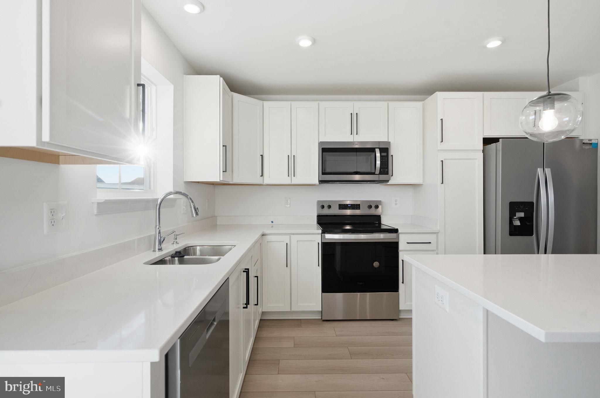 Tbb Tbb Outrigger Road, Unit WEXFORD Inwood, WV 25428 - Photo 8 of 34 a kitchen with stainless steel appliances granite countertop a sink stove and refrigerator