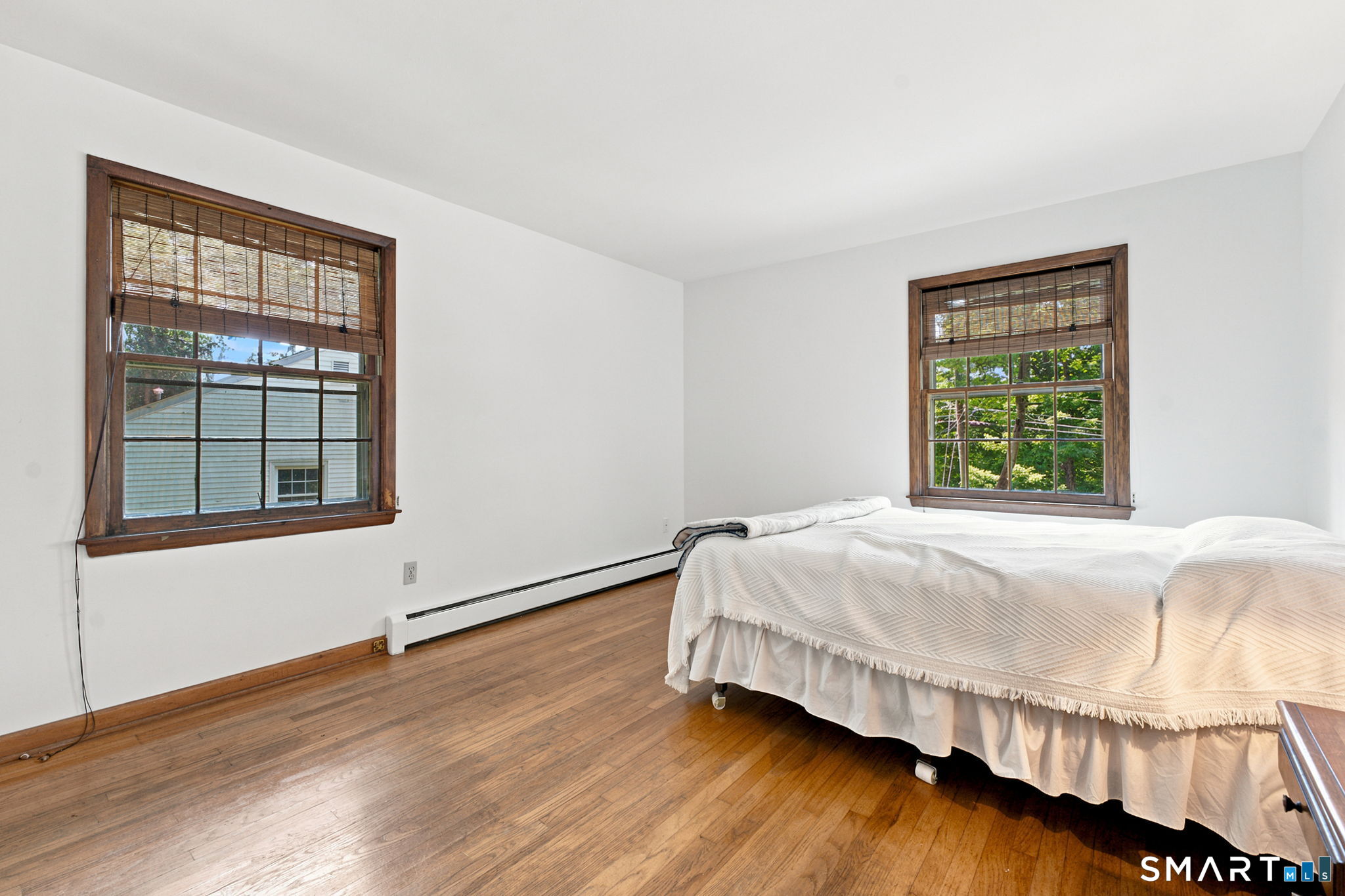 448 Mixville Road Cheshire, CT 06410 - Photo 14 of 32 a bed sitting in a bedroom next to a window