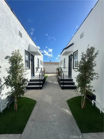 a view of house with yard and outdoor seating